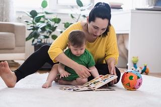 mother and baby playing on the floor together