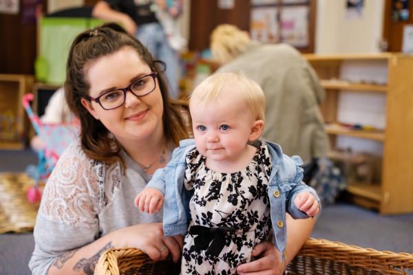 A woman and a baby in a playroom