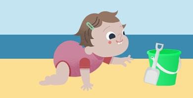 Picture of baby crawling towards a bucket on sand
